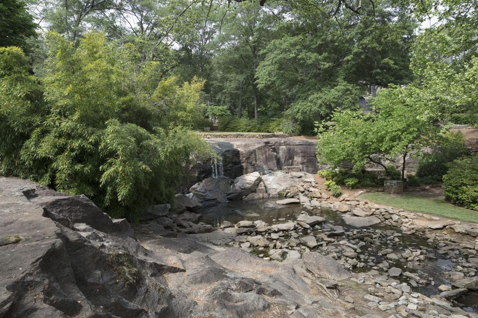 Stone terraces, greenery, and water at Rock Quarry Garden in Greenville.